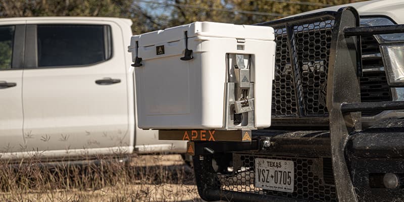 Closeup shot of a white Apex A45 cooler securely mounted to the front of a fleet truck