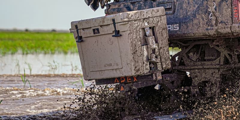 Dirty Khaki Apex cooler mounted to an ATV