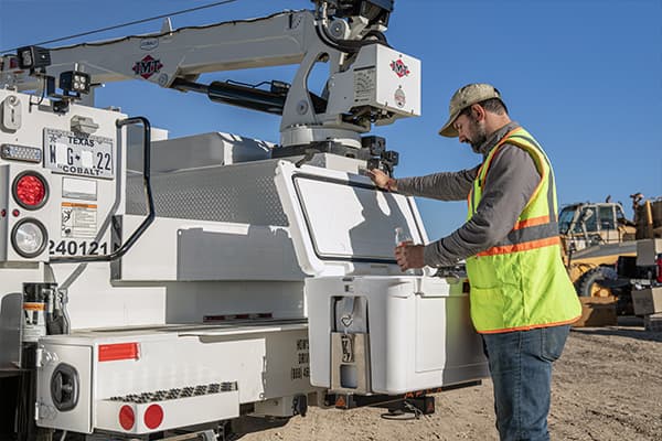 Worker taking a break to get water from a white Apex A45 Cooler